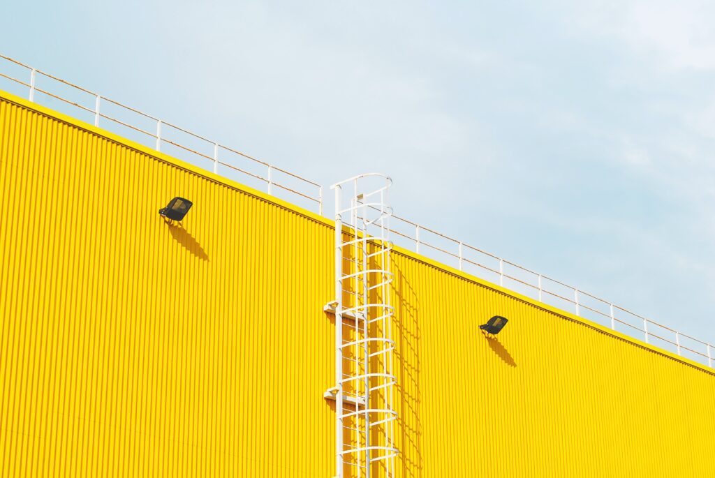 Diversified Manufacturer Develops New Smart Systems Business Models | Client Case 2 | Yellow Side of Building | Ladder