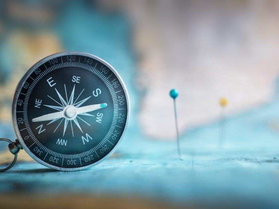 Analytics is a Journey | Compass on Map with Pins