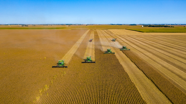 Future Proof Smart Farming | Tractors in Field from Above with Blue Sky
